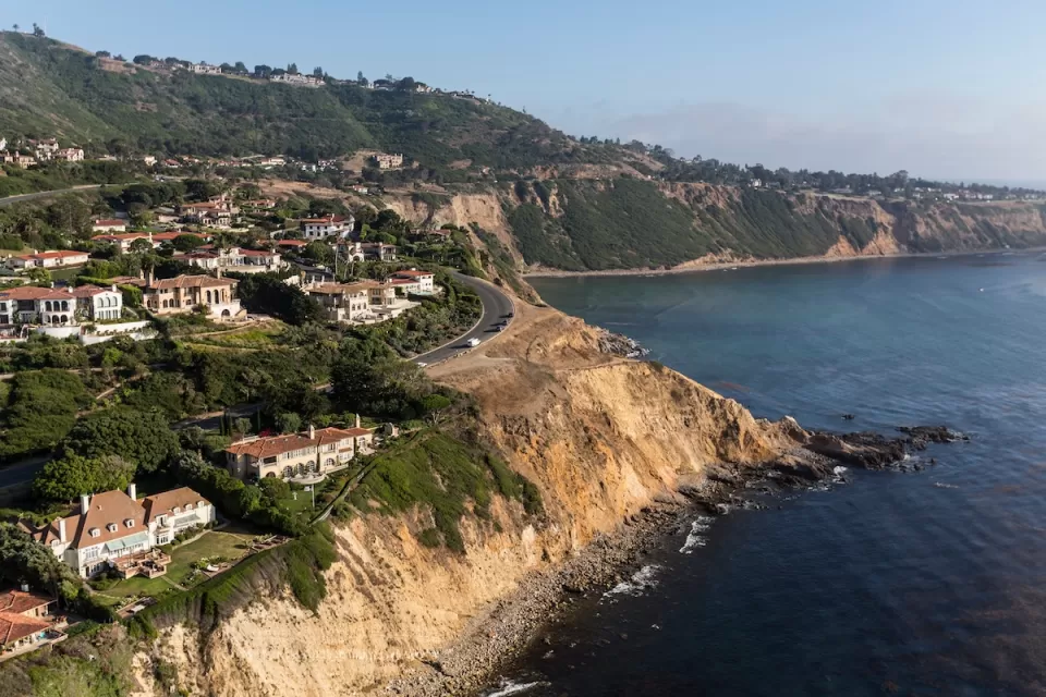 Aerial view of Rancho Palos Verdes coastal community with large homes on coastal bluffs on Pacific Ocean.